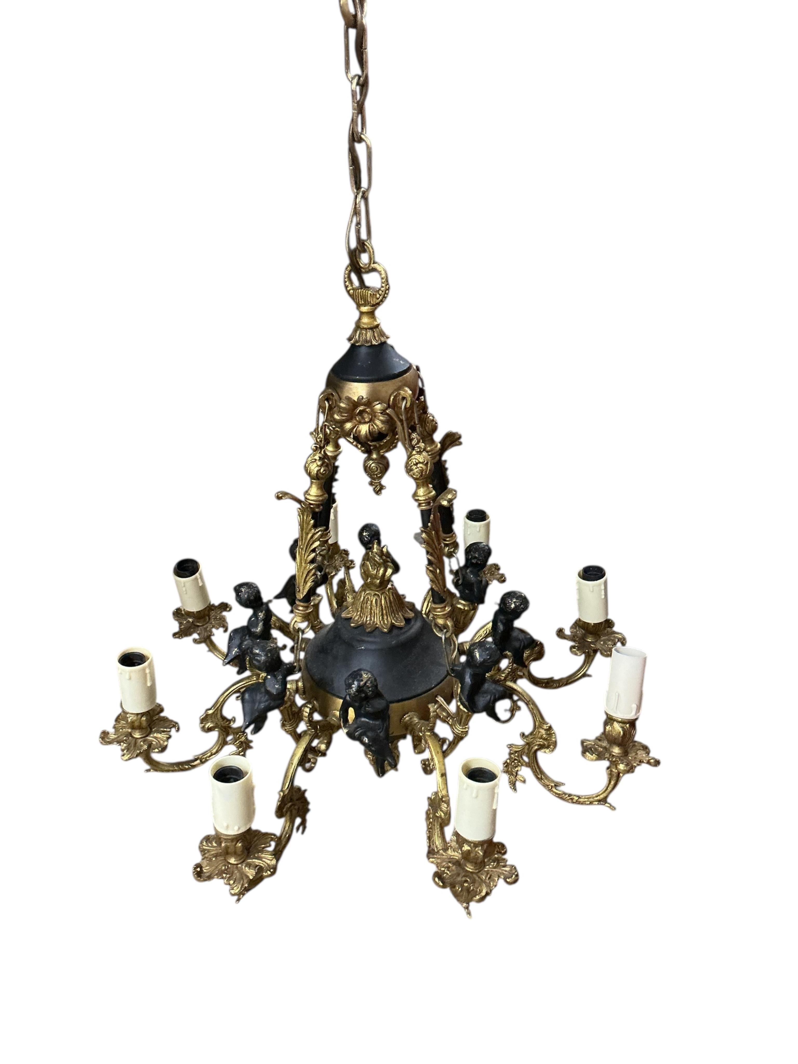 An eight branch gilt metal electrolier, cast with cherubs, width 60cm